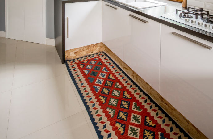 Vibrant rug adding a pop of color to the kitchen floor