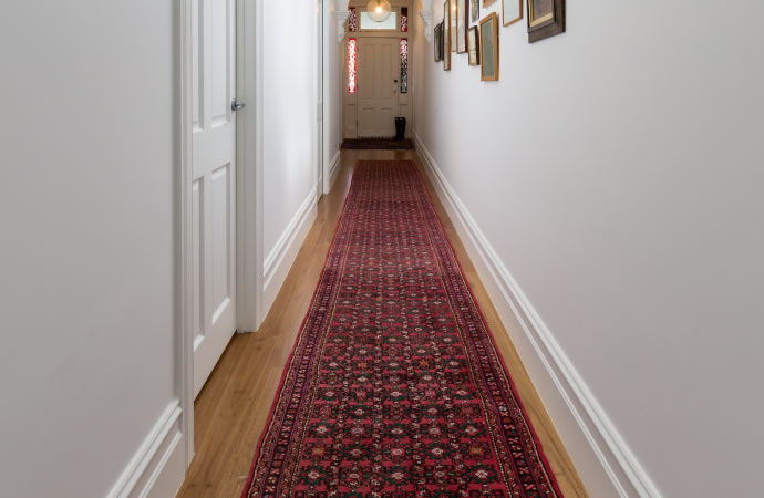 Radiant rug adding warmth and style to the corridor.